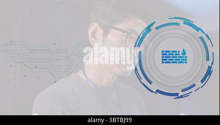 Pointing Korean speaker wearing glasses, lanyard toward firewall icon at tech event, copy space Stock Photo