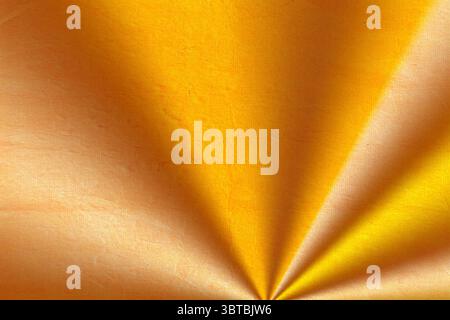 Golden-yellow textured material is showing radiating folds in 3D render with sunburst effect Stock Photo