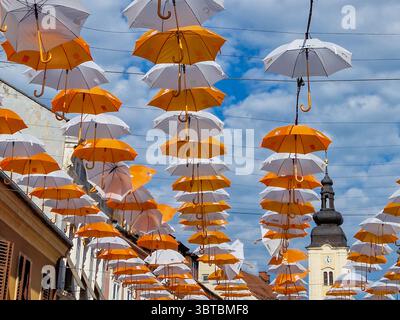 Different colours hanging umbrellas on Porcijunkulovo 2022 Stock Photo