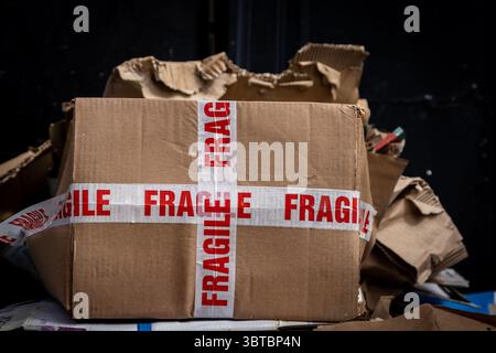A close up of an empty cardboard box with FRAGILE stickers, with selective focus Stock Photo