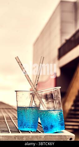 Blue slush drinks in plastic glasses abandoned on blackpool Promenade,UK Stock Photo