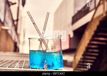 Blue slush drinks in plastic glasses abandoned on blackpool Promenade,UK Stock Photo