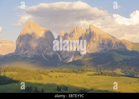 Majestic mountains in the golden light of the sunset with clouds and wide landscape, Alpe di Siusi, Dolomites, South Tyrol, Italy Stock Photo