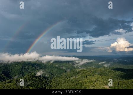 A classic example of extreme weather with a double rainbow forming after a thunderstorm in the mountains of North Carolina mid summer time.  ©Paul Tod Stock Photo