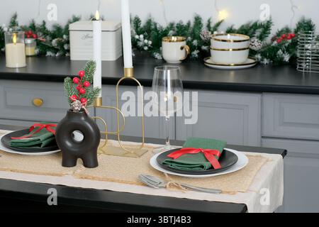 A beautifully arranged festive table featuring green napkins and charming decor. Stock Photo
