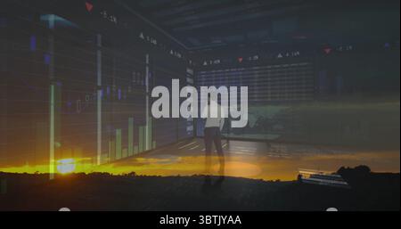 Examining white shirt executive analyzing market data on screens in control room, with sunset Stock Photo
