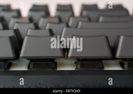 close-up macro view of black mechanical gaming keyboard keys, showing height and slope of the keys, designed for intense gaming or typing performance Stock Photo