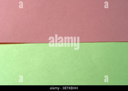 Sheets of red and yellow paper lie on the table, stationery background, close-up Stock Photo