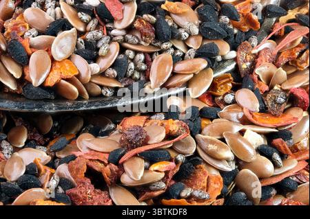 A mixture of aromatic spices and seeds, peppers and herbs for cooking meat and poultry close-up macro photography Stock Photo