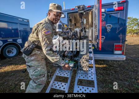 October 23, 2019 - Joint Base McGuire-Dix-Lakehurst, New Jersey, USA - U.S. Army Sgt. Quran T. Williams, Survey Team Member, 21st Weapons of Mass Destruction-Civil Support Team (21st WMD-CST), New Jersey National Guard, unloads a Talon IV robot during a training exercise at Joint Base McGuire-Dix-Lakehurst. The robot is used for reconnaissance and detection in chemical, biological, radiological, and nuclear environments. The 21st WMD-CST supports civil authorities at man-made or natural disasters by identifying chemical, biological, radiological, and nuclear substances, assess the consequences Stock Photo