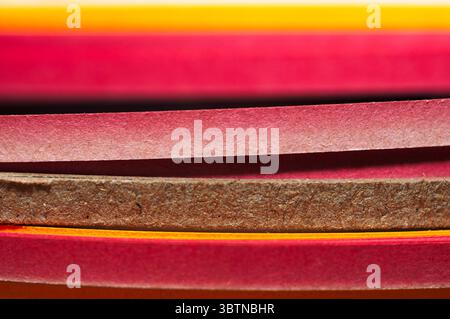 A vibrant close-up of multi coloured strips in flowing, waves. Perfect for abstract backgrounds, creative design, or craft and colour themed stock Stock Photo