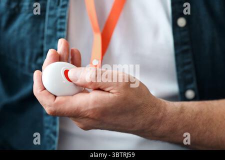 Unrecognizable old man pushing red button for emergency Stock Photo