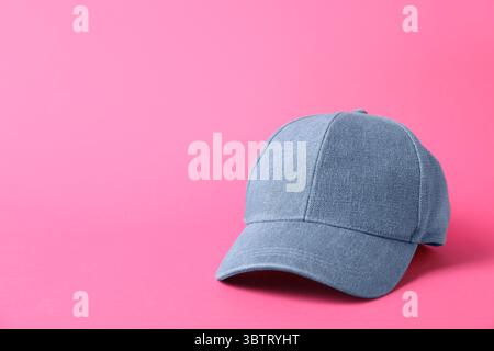 Denim baseball hat on pink background, closeup. Space for text Stock Photo