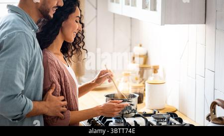 Romantic Middle Eastern Spouses Preparing Food Together At Home Stock Photo