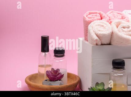 Soft pink folded towels on a light background,  ideal for mockups and design projects with space for text and logos. Stock Photo