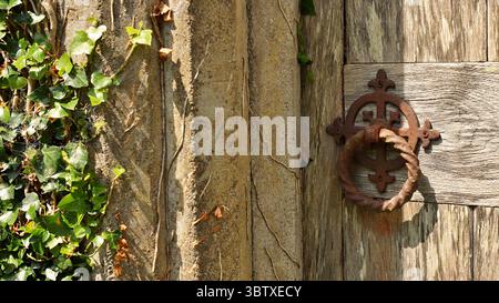 Old wooden door and old rusty knocker in Ireland. Stock Photo