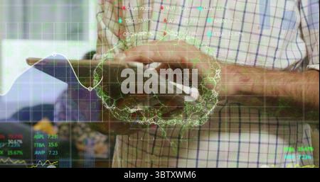 Tapping tablet, man wearing checkered shirt in office with wireframe brain graph and stock tickers Stock Photo