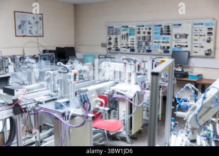 Flat design automation rigs are being shown in training workshop, with conveyors and control panels Stock Photo