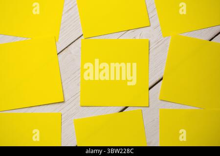 Yellow papers on wooden flooring Stock Photo