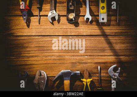 Flat design is showcasing pliers, screwdriver, wrench, hammer on wooden surface, copy space Stock Photo