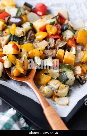 Roasted vegetabes on black slate background Stock Photo