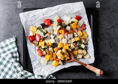Roasted vegetabes on black slate background Stock Photo
