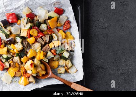 Roasted vegetabes on black slate background Stock Photo