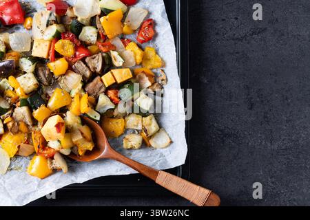 Roasted vegetabes on black slate background Stock Photo
