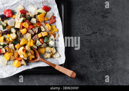 Roasted vegetabes on black slate background Stock Photo