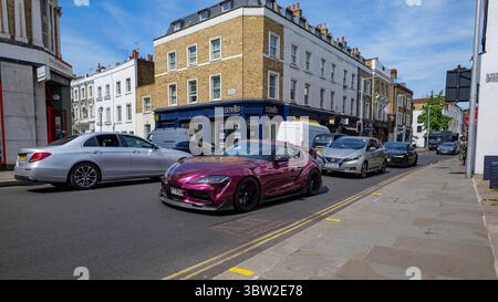 London - 06 21 2022: View of Fulham Road with a purple Toyota GR Supra in the foreground, Chelsea Stock Photo