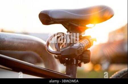 Bike Seat With Code Lock Close Up At Sunset In The Park Stock Photo