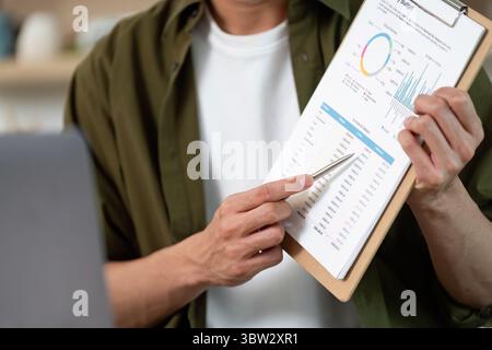 Work from Home: Professional analyzing data on clipboard during remote meeting Stock Photo