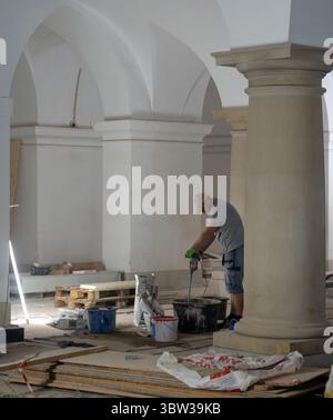 Berlin, Germany. 16th July, 2025. A worker mixes cement in a bowl on the construction site of the Hohenzollern crypt in Berlin Cathedral. During a press tour, visitors were given an insight into the ongoing renovation work. The crypt is one of the most important dynastic burial sites in Europe. Credit: Soeren Stache/dpa/Ģ����ý Live News Stock Photo