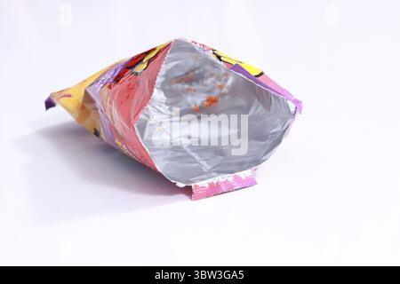 Used food wrapper and look at the silver color inside isolated on white background. Stock Photo