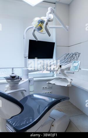 Modern Dental Office Interior Featuring a Comfortable Chair, Advanced Equipment, and Bright Lighting Designed for Patient Comfort and Efficient Dental Stock Photo