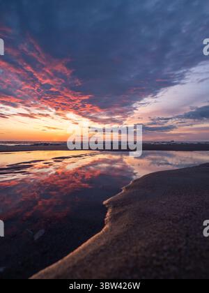 Dramatic Sunset at a beach on the island Sylt, Germany Stock Photo