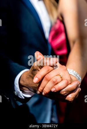 Interracial Couple Holding Hands and Diamond Engagement Ring, Close-Up ...