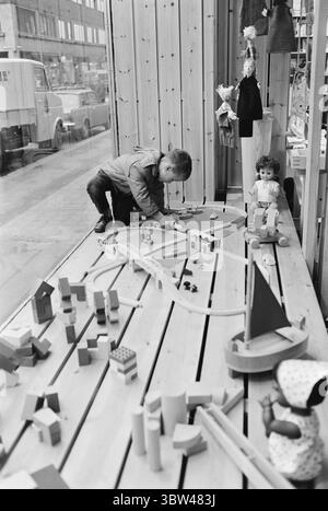 Aktuell 47b - 1 - 1969: Santa Claus shows the way!Parents, grandparents, aunts and uncles struggle to find the right Christmas present for small children. The only thing they know is that it should not be soft packages. Aktuell has visited A.S. Ritige Leker in Oslo.  Petter has to push the train. The mechanical railway set does everything itself, and thus the child is passivized. It does nothing itself. It is the children who should play, not the toys for them. Parents should note this.  Photo: Ivar Aaserud / Aktuell / NTB ***PHOTO NOT IMAGE PROCESSED*** *Text is auto translated* Stock Photo