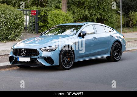 Mercedes AMG 4-Door Coupé parking on the street. The luxury car is colored in Vintageblau uni (vintage blue). Modern sports car from a German brand. Stock Photo