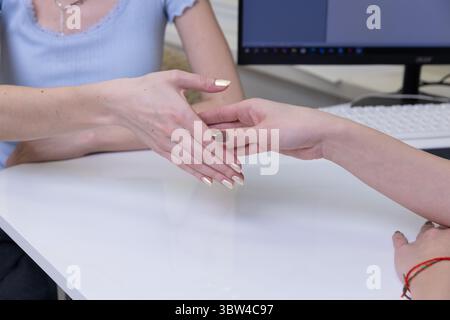 A Professional Handshake Between Two Individuals Signifying Agreement or Collaboration at a Modern Workplace Setting Stock Photo