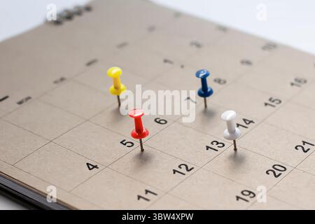 Embroidered pins on a calendar appointment Stock Photo