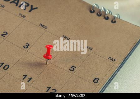 Embroidered pins on a calendar appointment Stock Photo