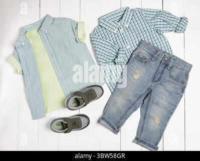 Men's casual outfits for man clothing set with t-shirt, gray shoes, shorts isolated on a white background, top view Stock Photo