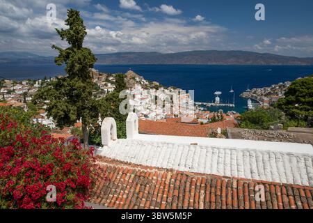 View over whitewashed houses and the port with Greek Orthodox church in foreground, Hydra, Saronic Islands, Greek Islands, Greece, Europe Stock Photo