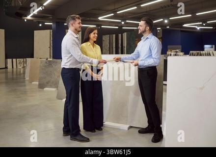 Consultant Advising Family Couple In Hardware Shop Stock Photo