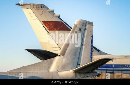 Tail and wings of large old airliners with the symbol of the Soviet Union isolated on a blue sky background Stock Photo