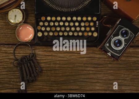 Typewriter, camera and clock on table Stock Photo