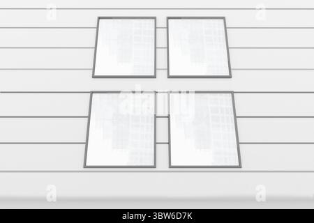 Four empty square frames are being displayed in flat design on grooved white wall, copy space Stock Photo