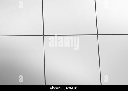 Flat design is showing close-up of light grey metal panel grid with thin dark joints Stock Photo