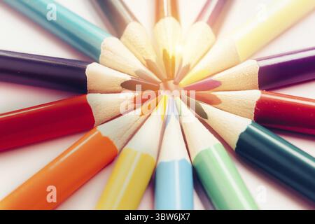 A figure of colored pencils in the shape of the sun with rays. The concept of creativity or development of the group. Abstract background. minimalism Stock Photo
